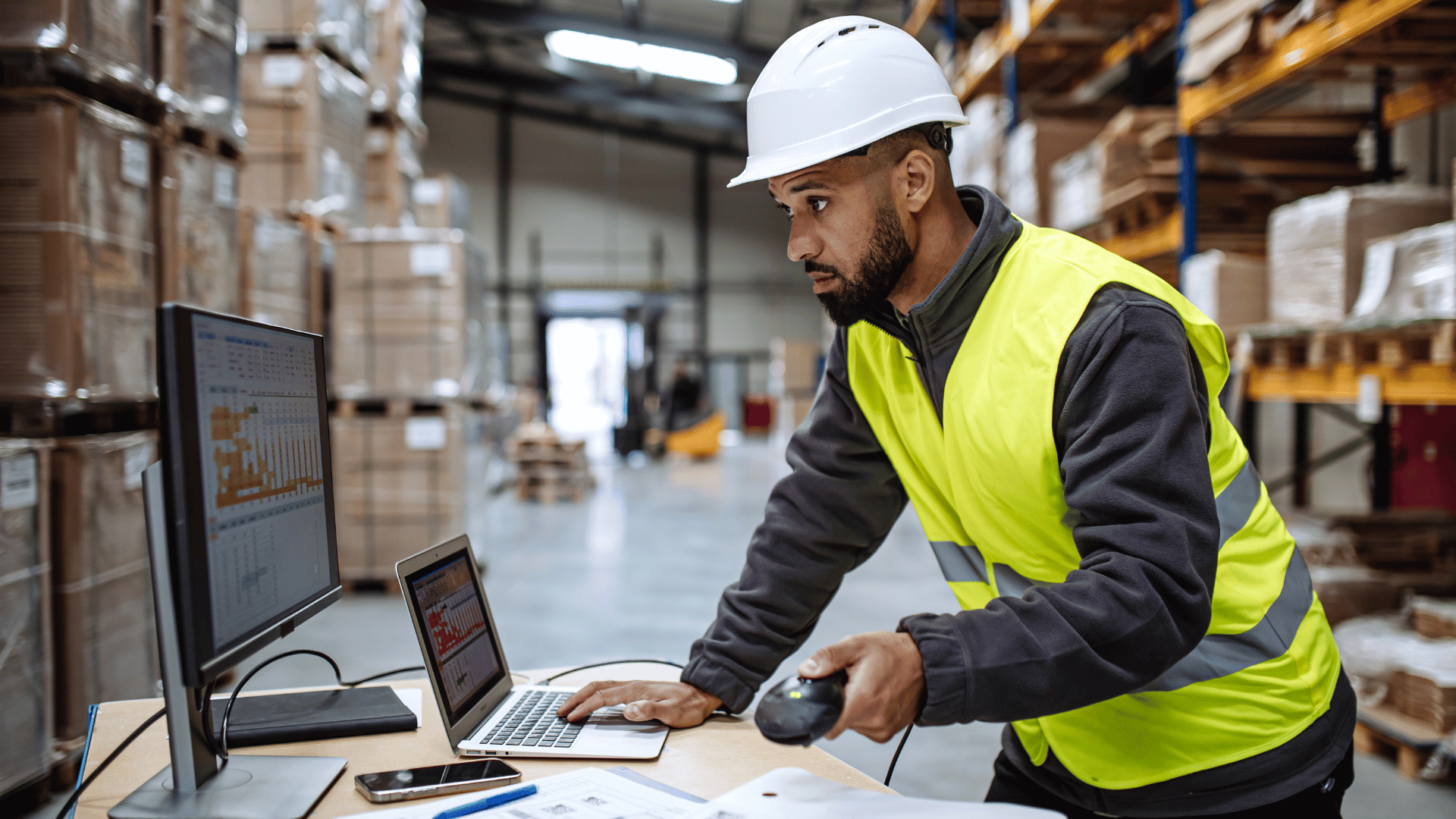 Warehouse worker scanning inventory that feeds Stacket's automated 3PL billing